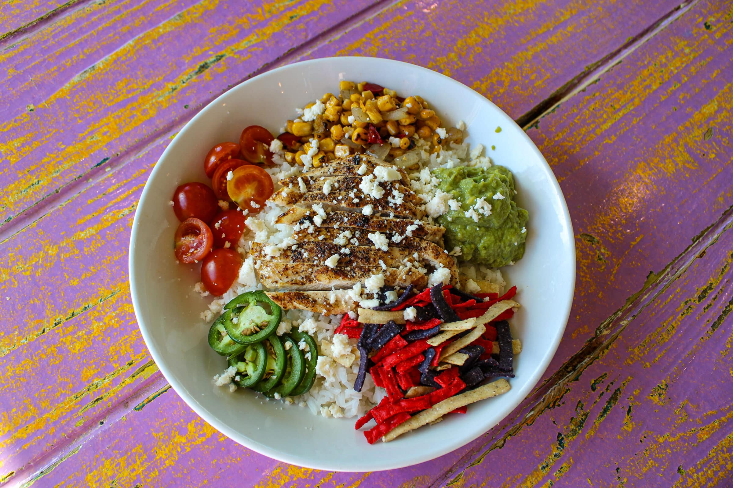 grilled chicken, roasted corn, cherry tomatoes, sliced jalapeños, guacamole, queso fresco, avocado ranch & tortilla strips, served over jasmine rice (gluten-sensitive option available
