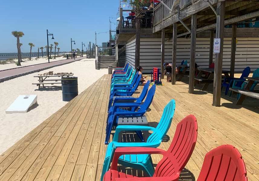 A row of chairs overlooking the beautiful biloxi beach at Shaggy's Biloxi Beach